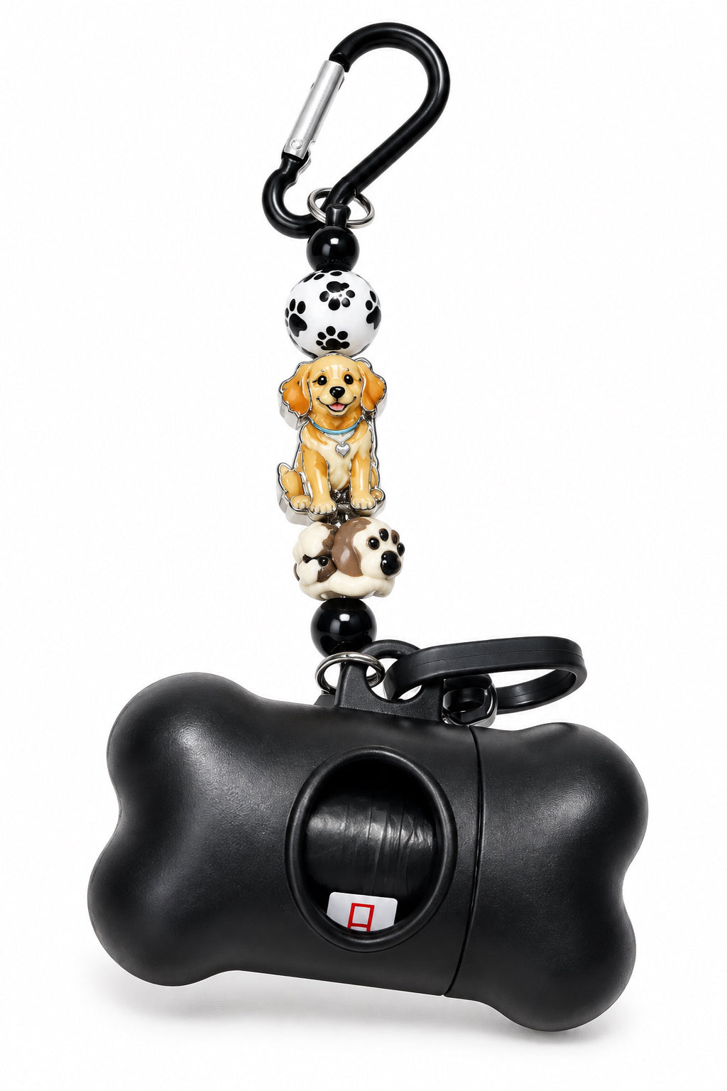 A black bone-shaped pet poop bag holder keychain with a carabiner and decorative dog beads is shown on a light gray surface. Part of a pink accessory is visible on the left edge.